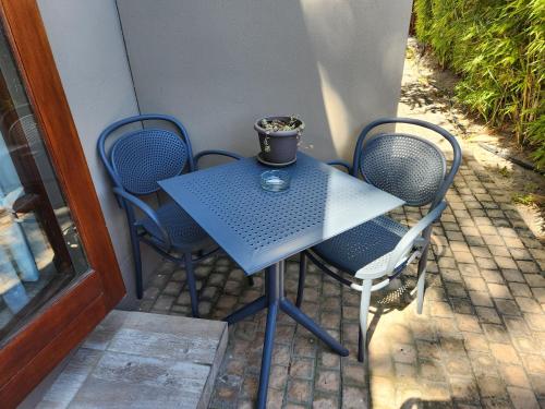 a blue table and chairs on a patio at Dilisca Guesthouse in Durbanville