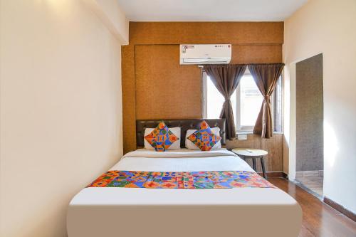 a bedroom with a large bed in a room at FabExpress Krishna in Kolkata