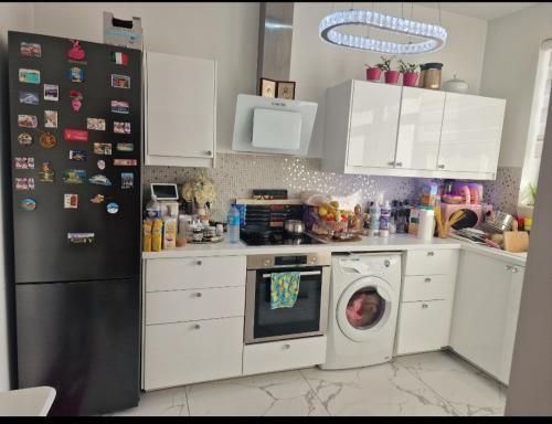 a kitchen with a refrigerator and a washing machine at Diva lux in Brussels