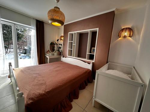 a bedroom with a bed and a window at IDYLLAKI dom z ogrodem i sauną in Dylaki