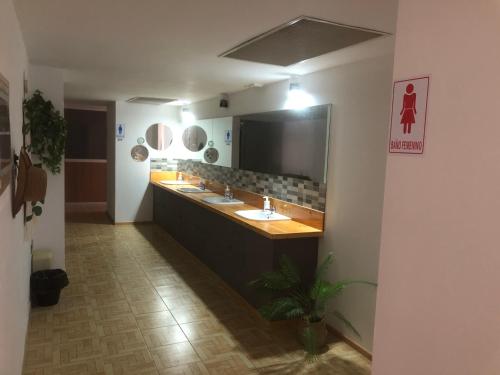 a bathroom with two sinks and a large mirror at Urban Hostel and Coworking in Arrecife