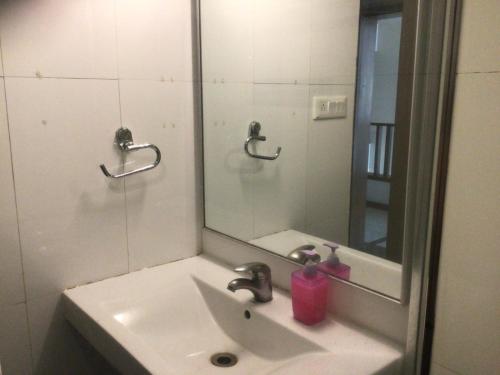 een badkamer met een wastafel en een spiegel bij IVY Studio in Pune