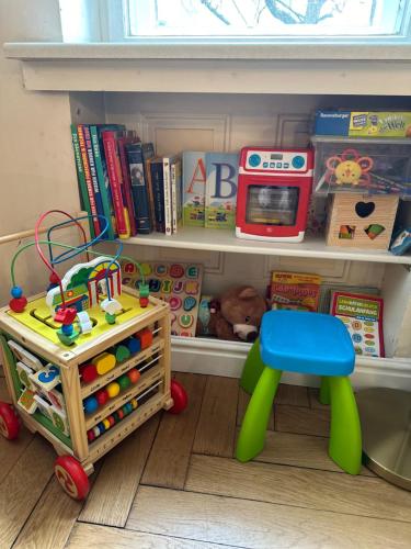 a playroom with a shelf with toys and a table at Hotel Astrid am Kurfürstendamm in Berlin