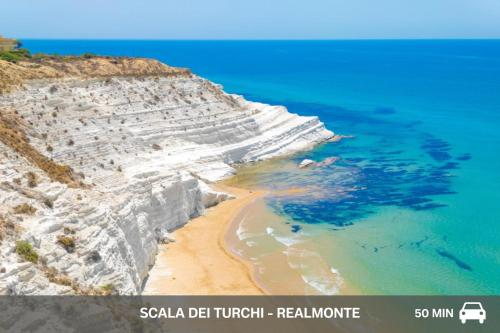a picture of a cliff with a beach and the ocean at Aparthotel Isabella in Sciacca