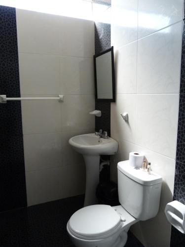 a bathroom with a toilet and a sink at Matryoshka in Ica