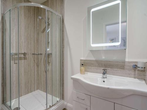 a bathroom with a shower and a sink and a mirror at 2 Bed in Usk 82392 in Trostrey