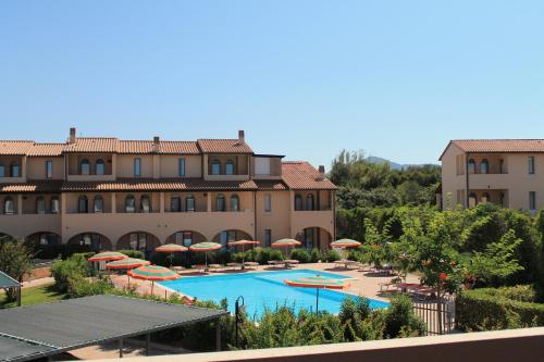 a view of a resort with a pool and umbrellas at Residenza dei Cavalleggeri in San Vincenzo