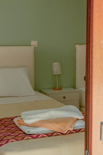 a bedroom with a bed and a lamp on a night stand at Villa Kalamitsi Luxury Villa in Apokorona Chania in Kariá