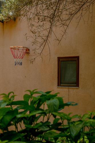 a basketball hoop on the side of a building at Villa Kalamitsi Luxury Villa in Apokorona Chania in Kariá