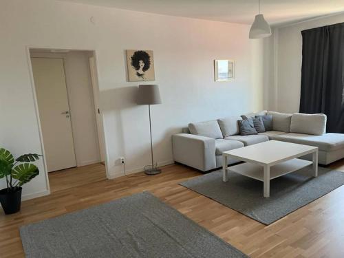 a living room with a couch and a table at Comfortable Apartment In Cozy Location in Gothenburg