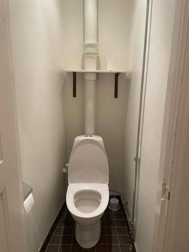 a bathroom with a toilet with a light above it at Luxury Apartment In City Centre in Gothenburg