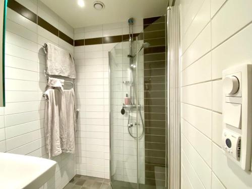 a bathroom with a shower and a sink at Luxury Apartment In City Centre in Gothenburg