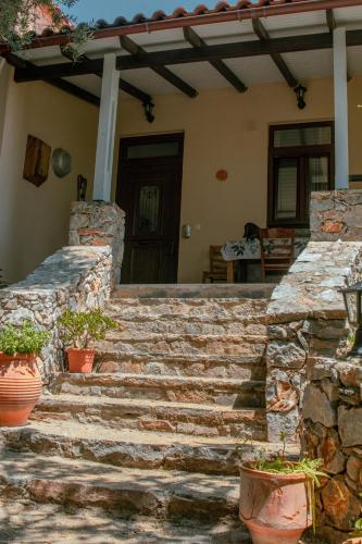 a set of stone stairs in front of a house at Villa Kalamitsi Luxury Villa in Apokorona Chania in Kariá