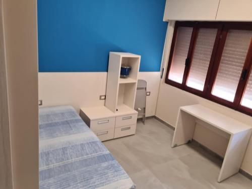 a hospital room with two beds and a mirror at ARCOBALENO by DIMORA CHIC in Novara