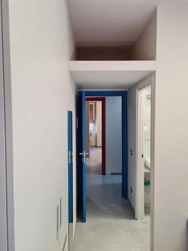 a hallway with blue and white doors and a room at ARCOBALENO by DIMORA CHIC in Novara