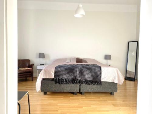 a bedroom with a bed with a black and white blanket at Luxury Apartment In City Centre in Gothenburg