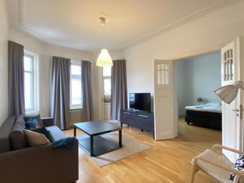 a living room with a couch and a bed at Luxury Apartment In City Centre in Gothenburg