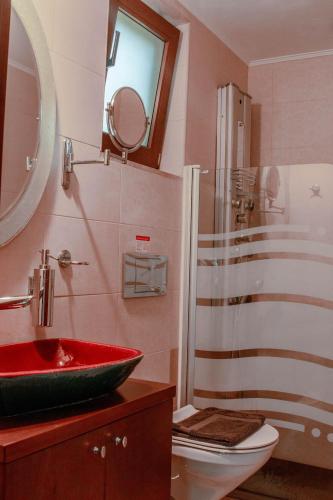 a bathroom with a red sink and a shower at Villa Kalamitsi Luxury Villa in Apokorona Chania in Kariá
