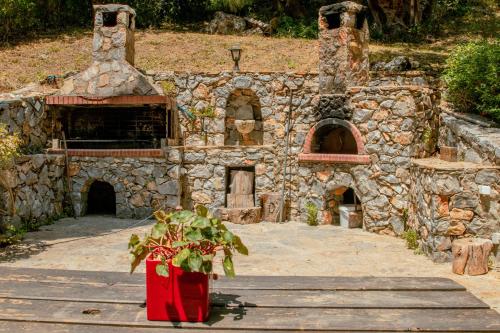 a stone building with a potted plant in front of it at Villa Kalamitsi Luxury Villa in Apokorona Chania in Kariá