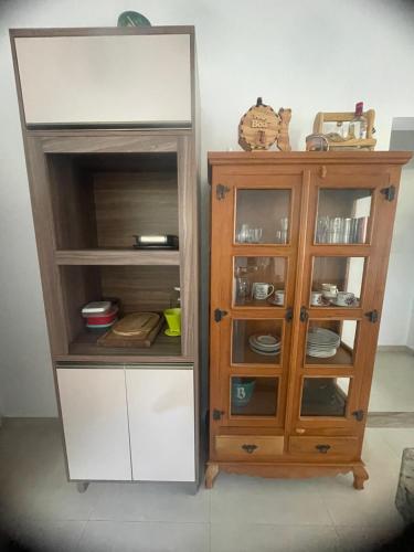 a wooden cabinet next to a cupboard at Praia dos ingleses Floripa in Florianópolis