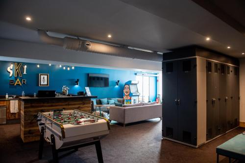 a living room with a foosball table in the middle at Fahrenheit Seven Val Thorens in Val Thorens