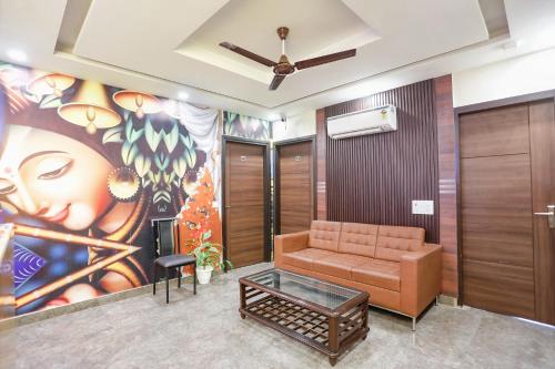 a lobby with a couch and a painting on the wall at FabHotel Nirvana Residency in New Delhi