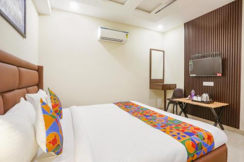 a hotel room with a bed and a television at FabHotel Nirvana Residency in New Delhi