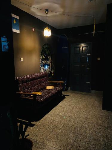 a dark room with a couch and a door at Vibes of Varkala Homestay in Varkala