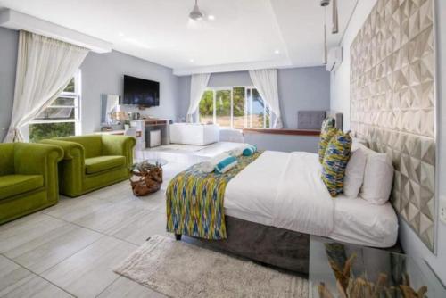 a bedroom with a large bed and a living room at Ecolux in Marracuene