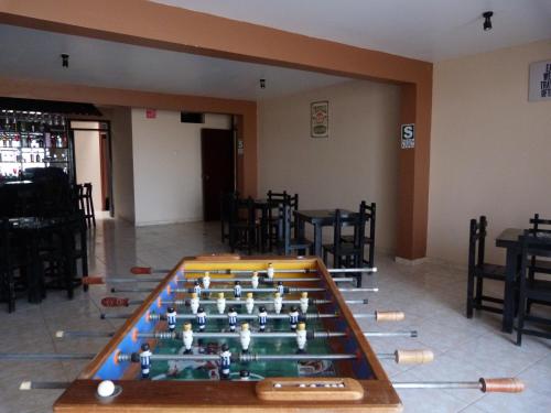 a large foosball table in a room with chairs at Matryoshka in Ica