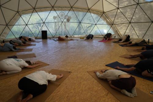 eine Gruppe von Menschen, die Yoga in einer Kuppel machen in der Unterkunft Biovilla Sustentabilidade in Palmela