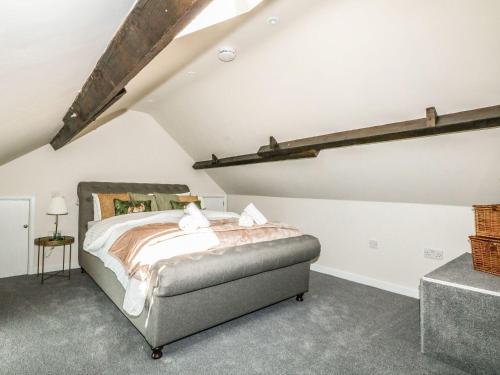 a bedroom with a bed in a attic at The Apple Loft at Jordan House in Weymouth