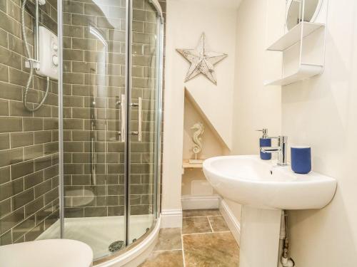 a bathroom with a shower and a sink at The Apple Loft at Jordan House in Weymouth