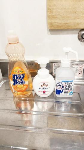 two bottles of laundry detergent and a bottle of cleaner at 花乃郷 赤羽 in Tokyo