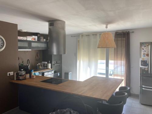 een keuken met een houten aanrecht in een kamer bij Maison avec piscine 1 chambres 