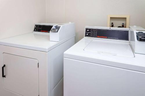 a laundry room with two washer and dryers at AmericInn by Wyndham New Richmond in New Richmond