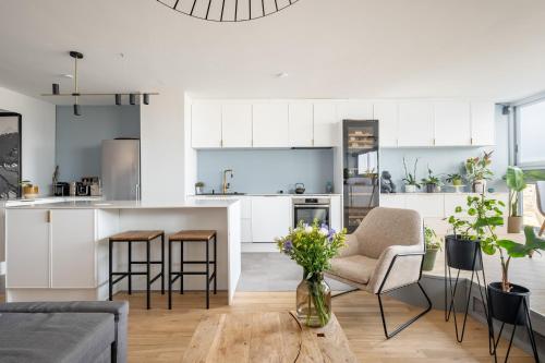 une cuisine et un salon avec une table et des chaises dans l'établissement Veeve - Riverside Heights, à Paris