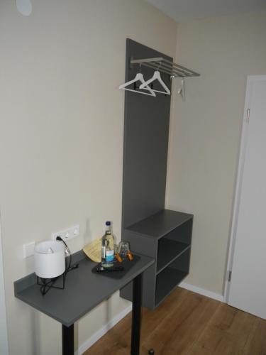 a kitchen with a black counter and a table at The Pharmacy Inn in Lemgo
