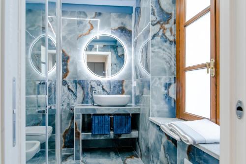 a bathroom with a sink and a mirror at Luxury For Groups & Families in city center in Turin