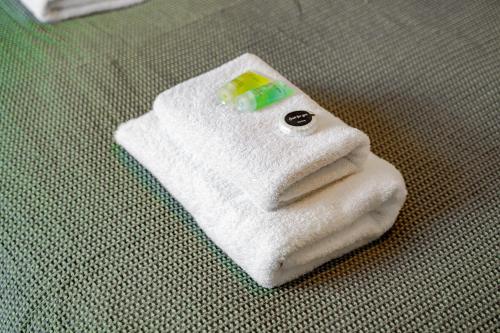 a white towel sitting on top of a bed at Cosy 2 bed home in Hoole perfect for your Chester break in Chester