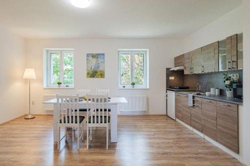 a kitchen with a white table and chairs in a room at TVM Ostrava 1 in Ostrava