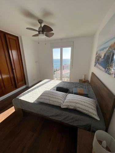 a bedroom with a large bed with a large window at Luxury Penthouse Playas de torrevieja 6pax in Torrevieja