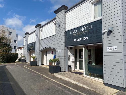 a row of buildings on a street with a hotel at Ostal Pau Universite - Sure Hotel Collection by Best Western in Pau