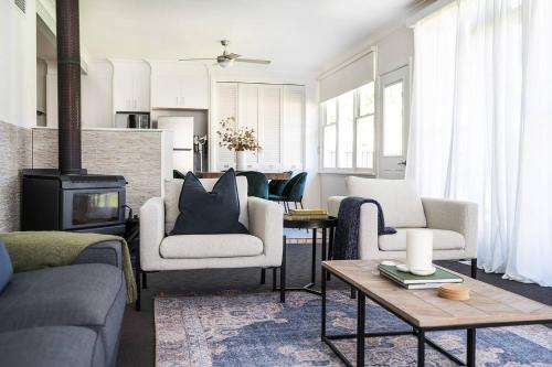 a living room with couches and a stove at Bancroft House on Scenic Mudgee Golf Course in Mudgee