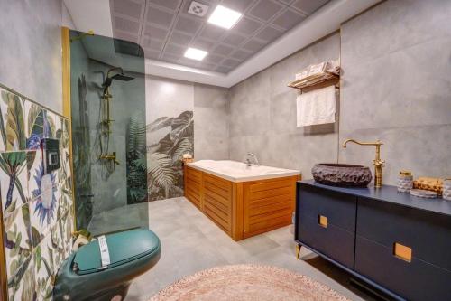 a bathroom with a shower and a sink and a tub at Kerem ile Aslı Butik Hotel in Melikgazi