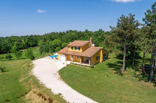 a house on a hill with a gravel road at Villa Kristina by Briskva in Pazin