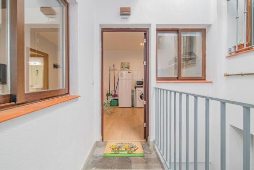 a hallway of a house with a door and window at Apartamento Gloria Bendita in Granada