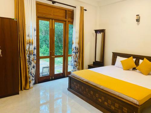 a bedroom with a bed and a large window at Happy Haven in Hikkaduwa