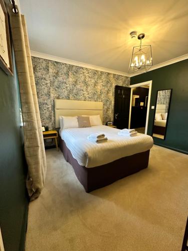 a bedroom with a large bed and a mirror at Lamp Light Rooms in Clifden