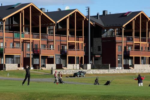 a group of people standing in front of a building at Levi Suites Levin Klubi in Levi